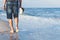 Man walks on the sea beach