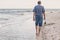 Man walks on the sea beach