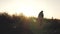 Man walks at sunset near stone crosses