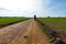 Man walks thorugh the fields- The french Way of `Camino de Santiago` in Winter. Pilgrimages on their journey through Spain