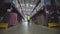 A man walks through the warehouse view from the back slowmotion. A worker walks through a factory warehouse. Rear view