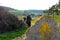 Man walks after the yellow arrow - The french Way of `Camino de Santiago` in Winter. Pilgrimages on their journey through Spain