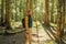 man in warm clothes enjoys a walk in a pine forest