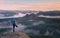 Man in warm jacket with backpack in spring rockx mountains