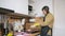 Man washes dishes dancing and listening music in headphones