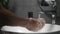 Man washes hands in sink with foam to wash skin and water flows through hands. Concept of health, cleaning and preventing germs an