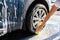 A man washes his car with foam at a self-service car wash, wheels and tires close-up