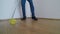 Man washes the parquet floor with the yellow mop