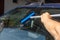 A man washes the windshield in the car at the station, Improves visibility on the road, increases driver safety