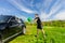 Man Washing Black Car in Green Field