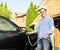 Man washing car on driveway