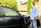 Man washing car on driveway