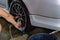 Man washing car wheel rims, on a car wash