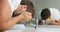 Man washing face rinsing soap from skin in sink under running cold water