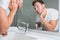 Man washing face in sink in bathroom rinsing after shaving. Home lifestyle copyspace