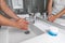 Man washing hands in hot water bathroom faucet sink running water for clean wash