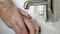 Man Washing His Dirty Hands With Soap Under Running Water