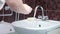 Man Washing His Hands at the Bathroom With Water, Soap and Foam. It`s important to wash hands in order to avoid virus