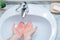 A Man is washing his hands with soap in bathroom