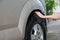 Man washing a tyre wheel car with black sponge