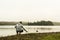 Man watching feeding ducks standing at lake of two rivers algonquin national park Ontario Canada grey morning atmosphere