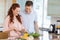 Man watching his girlfriend preparing a salad