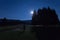 Man watching moon in golf course of Cansiglio Forest