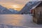 Man watching sunset over mountains and lake Predil in winter