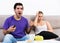 Man watching tv ignoring frustrated girl