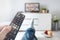 Man watching TV, lying on sofa, legs on table