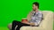 Man watching TV and smiling. Green screen