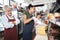 Man Watching Worker Cutting Cheese At Counter