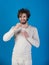 Man with water glass on blue background, hangover.