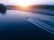 Man water skiing on lake behind boat