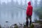 Man in waterproof jacket fishing on lake