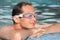 Man in watersport goggles swimming in pool