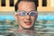 Man in watersport goggles swimming in pool