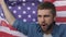 Man waving american flag, celebrating victory of presidential candidate, slow-mo