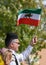 Man Waving Iranian Shir o Khorshid Flag in Toronto