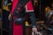 Man wear medieval uniform at the market stall. Red and black suit on a history revival recreation of the lovers of Teruel