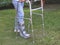 a man wearing aircast boot walking on green grass with orthopedic walker