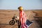 Man wearing american flag cape and golden helmet