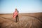 Man wearing american flag cape and golden helmet walking away