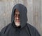 Man Wearing a Black Hooded Cape One Eye