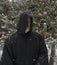 Man Wearing a Black Hooded Cape Snow Falling