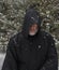 Man Wearing a Black Hooded Cape Snow Falling no Eyes