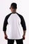 Man wearing black white raglan t-shirt 3/4 sleeve in back view with mockup concept
