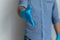 Man wearing blue rubber latex gloves offering hand for shake