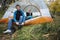 Man Wearing Boot While Woman Relaxing In Tent