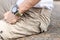 Man wearing brown cargo pants and sitting in the nature park